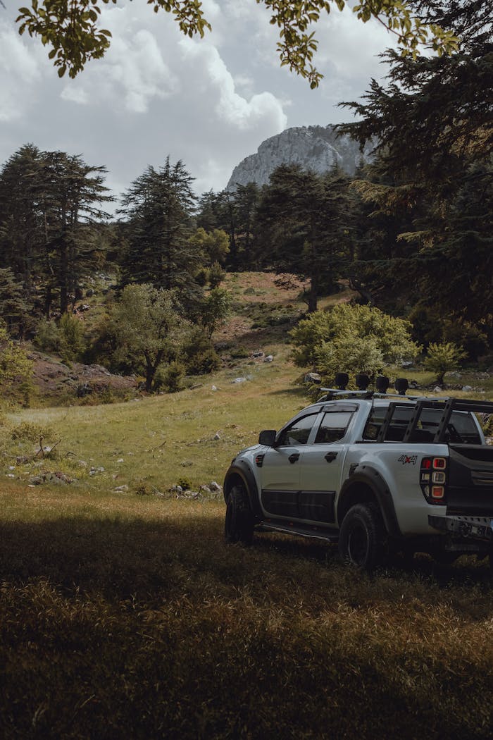 A rugged SUV parked in a lush mountainous area, perfect for adventure seekers.